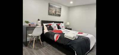 a bedroom with a bed and a desk and a chair at Master bedroom in Mississauga