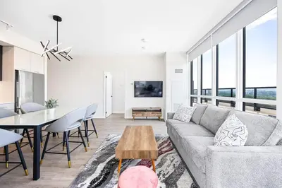 a living room with a couch and a table at Spacious 3-Bedroom SkyLoft with Beautiful City Views and Parking in Toronto
