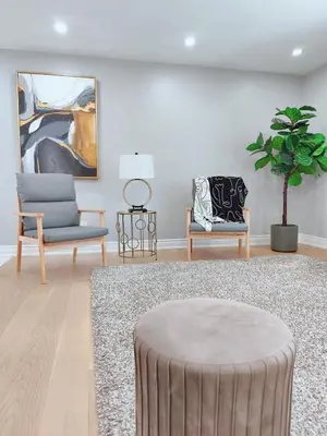 a living room with two chairs and a table at 5 Bed 4Bath 9 Parking Lakeside Retreat in Ajax
