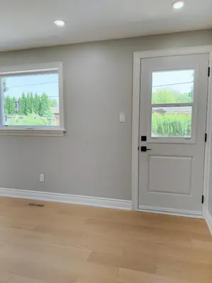 an empty room with a door and two windows at 5 Bed 4Bath 9 Parking Lakeside Retreat in Ajax