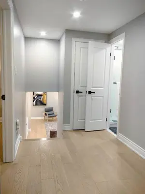 an empty living room with white walls and white doors at 5 Bed 4Bath 9 Parking Lakeside Retreat in Ajax