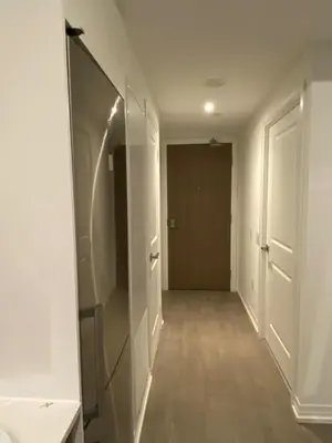 an empty hallway with a mirror and a closet at Luxury All-Inclusive One-Bedroom Condo in Downtown in Toronto
