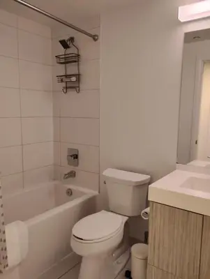 a bathroom with a toilet and a tub and a sink at Luxury All-Inclusive One-Bedroom Condo in Downtown in Toronto