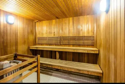 a sauna with wooden walls and benches and lights at Cozy Condo Midtown Toronto in Toronto