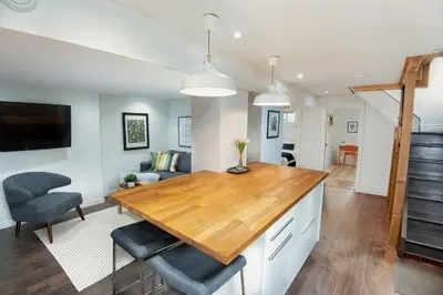 a kitchen and living room with a table and chairs at East Toronto BNB in Toronto