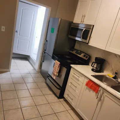 a kitchen with a stainless steel refrigerator and a sink at Bloor&Beyond- Free Wifi-Next to Subway Union Line in Toronto