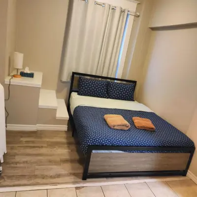 a bedroom with a bed with two towels on it at Bloor&Beyond- Free Wifi-Next to Subway Union Line in Toronto