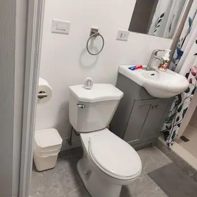 a bathroom with a toilet and a sink at Bloor&Beyond- Free Wifi-Next to Subway Union Line in Toronto