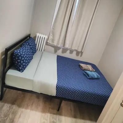 a small bed in a small room with a window at Bloor&Beyond- Free Wifi-Next to Subway Union Line in Toronto