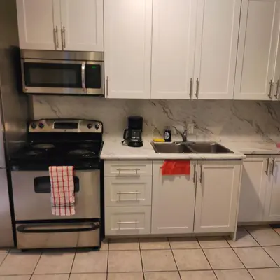 a kitchen with a stainless steel stove and a sink at Bloor&Beyond- Free Wifi-Next to Subway Union Line in Toronto