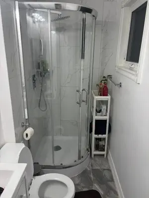 a bathroom with a shower and a toilet at Home in Scarborough, near GO station, TTC and UoT in Toronto