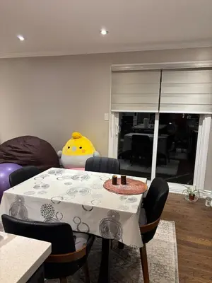 a dining room with a table and a couch at Home in Scarborough, near GO station, TTC and UoT in Toronto