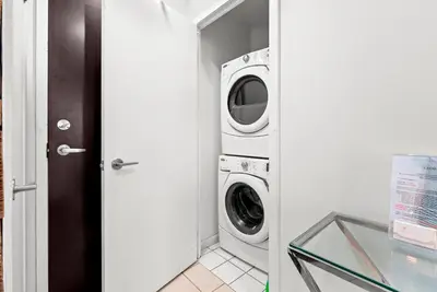 a laundry room with a washer and dryer at 1 Bedroom Condo with Balcony Fort York Downtown Toronto in Toronto