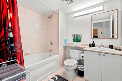 a bathroom with a tub and a toilet and a sink at 1 Bedroom Condo with Balcony Fort York Downtown Toronto in Toronto