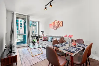 a living room with a table and a couch at 1 Bedroom Condo with Balcony Fort York Downtown Toronto in Toronto