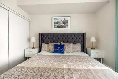 a bedroom with a large bed with a blue pillow at High Floor 1 Bedroom plus Den Condo Apartment City View North York Toronto in Toronto