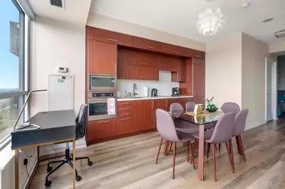 a kitchen and dining room with a table and chairs at High Floor 1 Bedroom plus Den Condo Apartment City View North York Toronto in Toronto