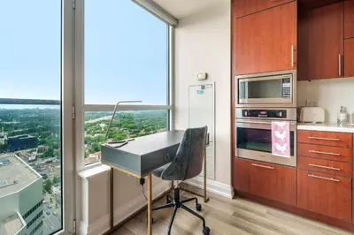 a kitchen with a desk in front of a window at High Floor 1 Bedroom plus Den Condo Apartment City View North York Toronto in Toronto