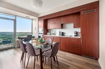 a kitchen and dining room with a table and chairs at High Floor 1 Bedroom plus Den Condo Apartment City View North York Toronto in Toronto