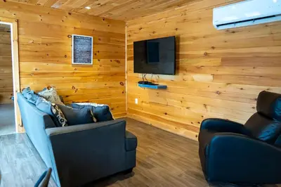 a living room with a couch and a flat screen tv at Winter at Wildwood in Bailieboro