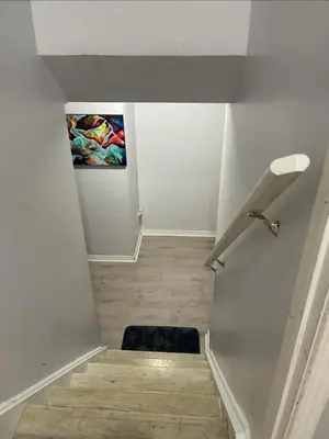 a stairway with a painting on the wall at Peace Apartment in Brampton