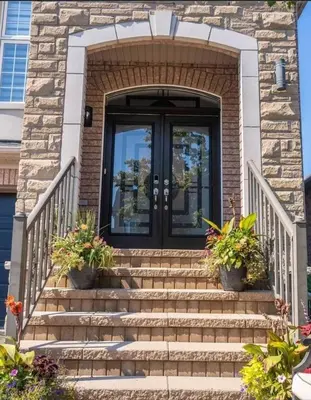 a front door of a house with stairs and plants at Peace Apartment in Brampton