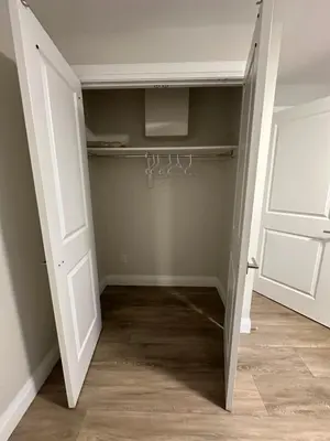 a walk in closet with a door and a closet at Spacious 2 Bedroom & 2 Bathroom Suit Near Fairview Mall & Waterloo Airport in Kitchener