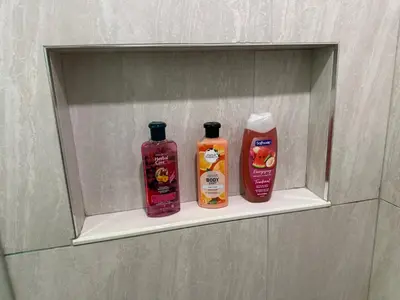 a shelf in a bathroom with two bottles of cleaner at Spacious 2 Bedroom & 2 Bathroom Suit Near Fairview Mall & Waterloo Airport in Kitchener