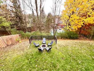 a picnic table and two chairs in a yard at Spacious 2 Bedroom & 2 Bathroom Suit Near Fairview Mall & Waterloo Airport in Kitchener