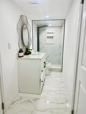 a white bathroom with a sink and a mirror at Modern 2BR suite Kitchen Workspace Laundry in London