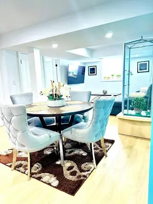a dining room with a table and chairs at Modern 2BR suite Kitchen Workspace Laundry in London