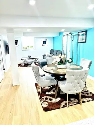 a living room with a table and chairs at Modern 2BR suite Kitchen Workspace Laundry in London