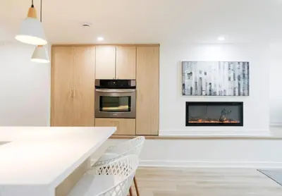 a kitchen with a stove and a fireplace at The Ember Suite in Peterborough