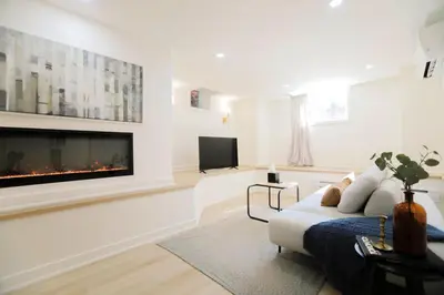 a living room with a fireplace and a couch at The Ember Suite in Peterborough