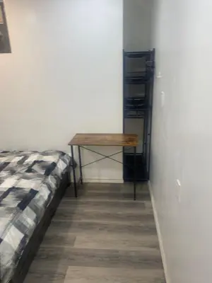 a bedroom with a table and a bed in a room at Private Room In Cambridge B13 in Cambridge