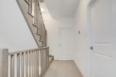 a hallway with a staircase and a glass door at Downsview Park Luxury Townhome near Yorkdale Transit in Toronto