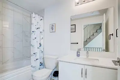 a bathroom with a toilet and a sink and a shower at Downsview Park Luxury Townhome near Yorkdale Transit in Toronto