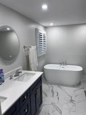 a bathroom with a tub and a sink and a mirror at Beautiful Lake Side Neighbourhood Home in Ajax, ON in Ajax