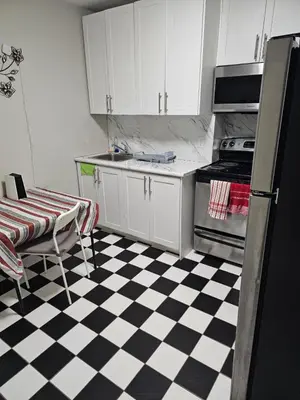 a kitchen with a black and white checkered floor at Toronto Holiday Home in Toronto
