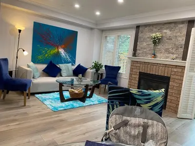 a living room with a couch and a fireplace at House of 3 Bed 3 Wash-Crib-King Bed-85' TV-Wrkspce in Oakville