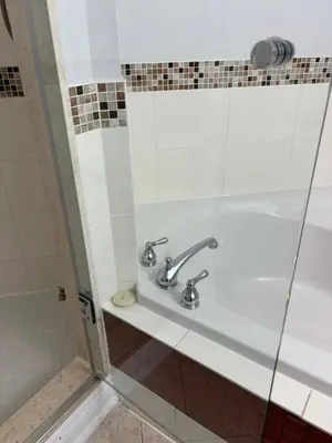 a bathroom with a sink and a shower at House of 3 Bed 3 Wash-Crib-King Bed-85' TV-Wrkspce in Oakville