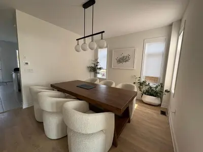 a dining room with a wooden table and chairs at Season Bliss - Blue Mountain Ski & Wasaga Beach in Wasaga Beach