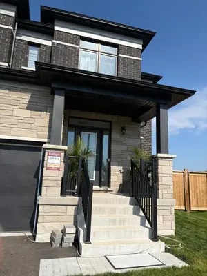 a house with a front door and stairs at Season Bliss - Blue Mountain Ski & Wasaga Beach in Wasaga Beach