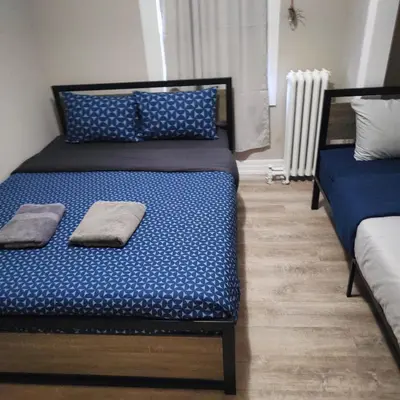 a bedroom with two beds with blue sheets at Full Downtown Access-Central Location-Self Checkin in Toronto