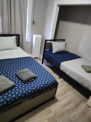 two beds in a room withthritisthritislictslictslicts at Full Downtown Access-Central Location-Self Checkin in Toronto