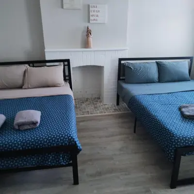 two beds in a room with a fireplace at Full Downtown Access-Central Location-Self Checkin in Toronto