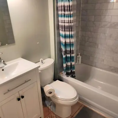 a white bathroom with a toilet and a sink at Full Downtown Access-Central Location-Self Checkin in Toronto
