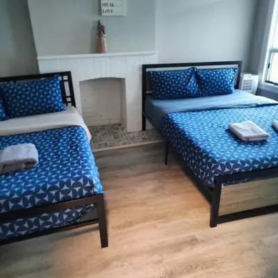 two beds in a room with a fireplace at Full Downtown Access-Central Location-Self Checkin in Toronto
