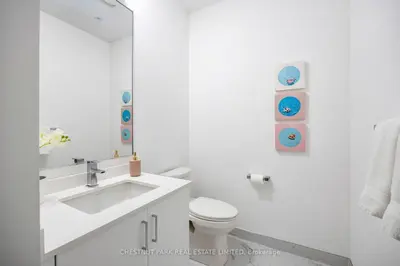 a white bathroom with a sink and a toilet at Waterfront Modern Vila in Innisfil