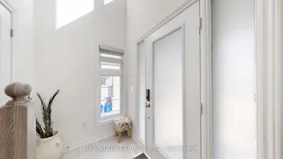 a white hallway with a mirror and a window at Modern in Richmond Hill in Richmond Hill